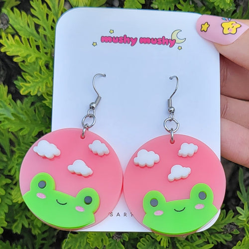 Adorable frog with clouds above and pink circle background. Cute cottage core style