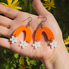 Load image into Gallery viewer, small white flowers hanging from orange arch earrings
