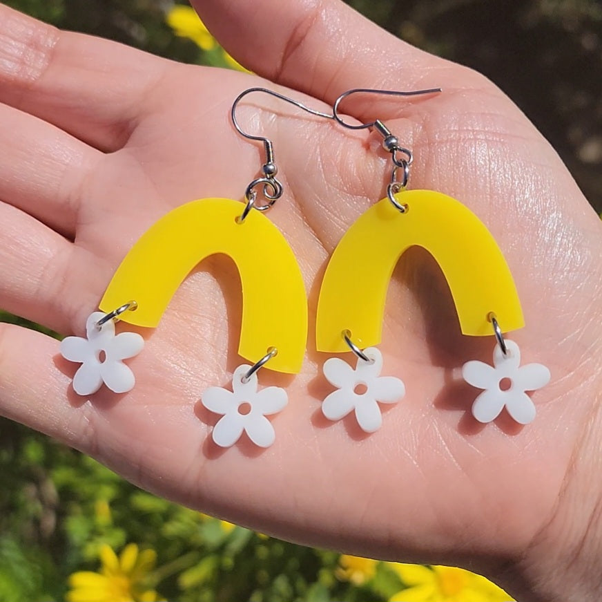 white flowers hanging from yellow arch with stainless steel hooks earrings